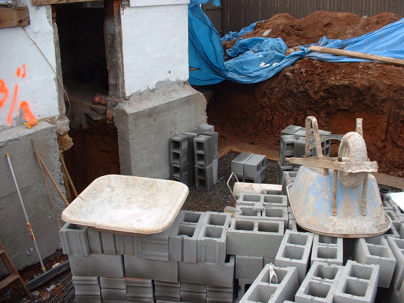 In this picture you can see the concrete is poured to support the existing walls.
