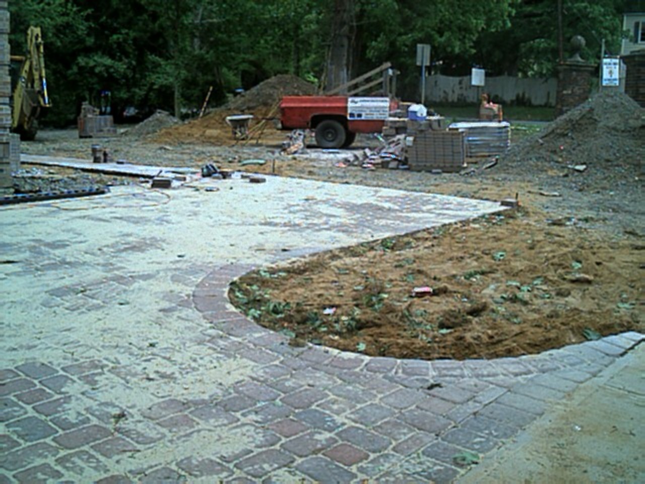 From the main entrance, the brick pavers curve into a parking section