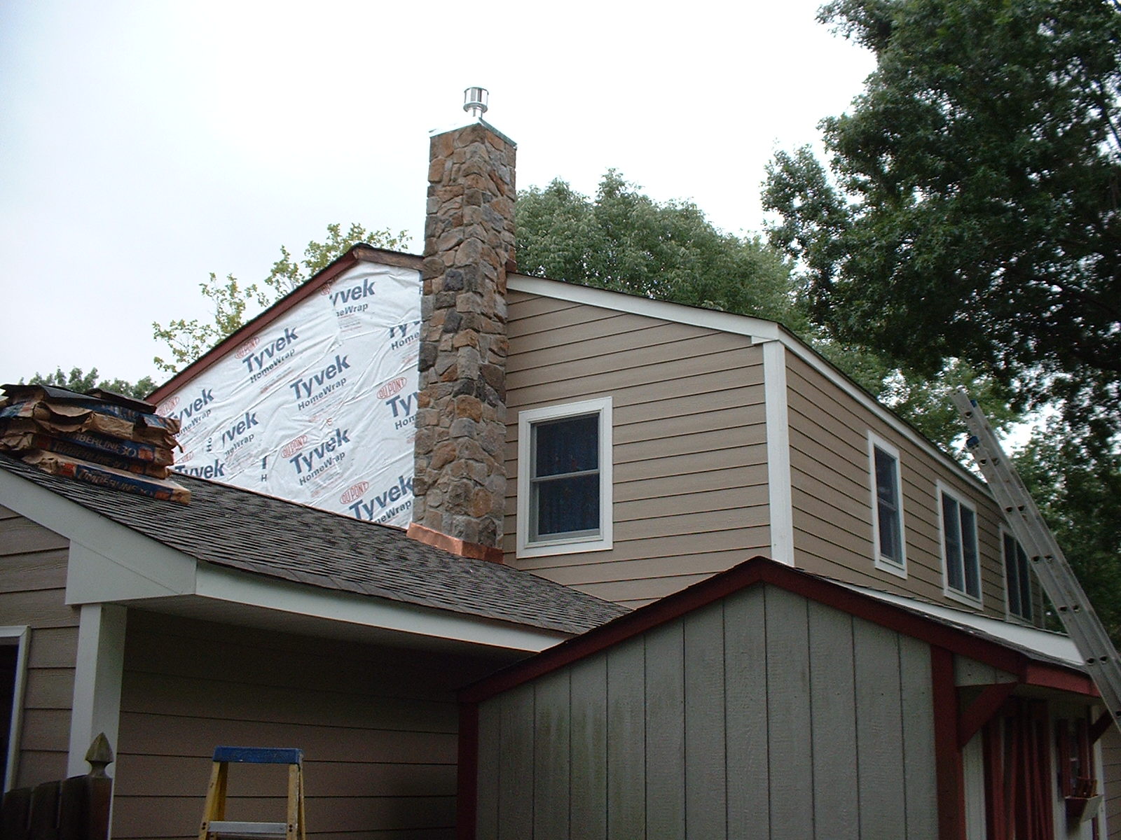 The siding is being done on the upper half of the house.