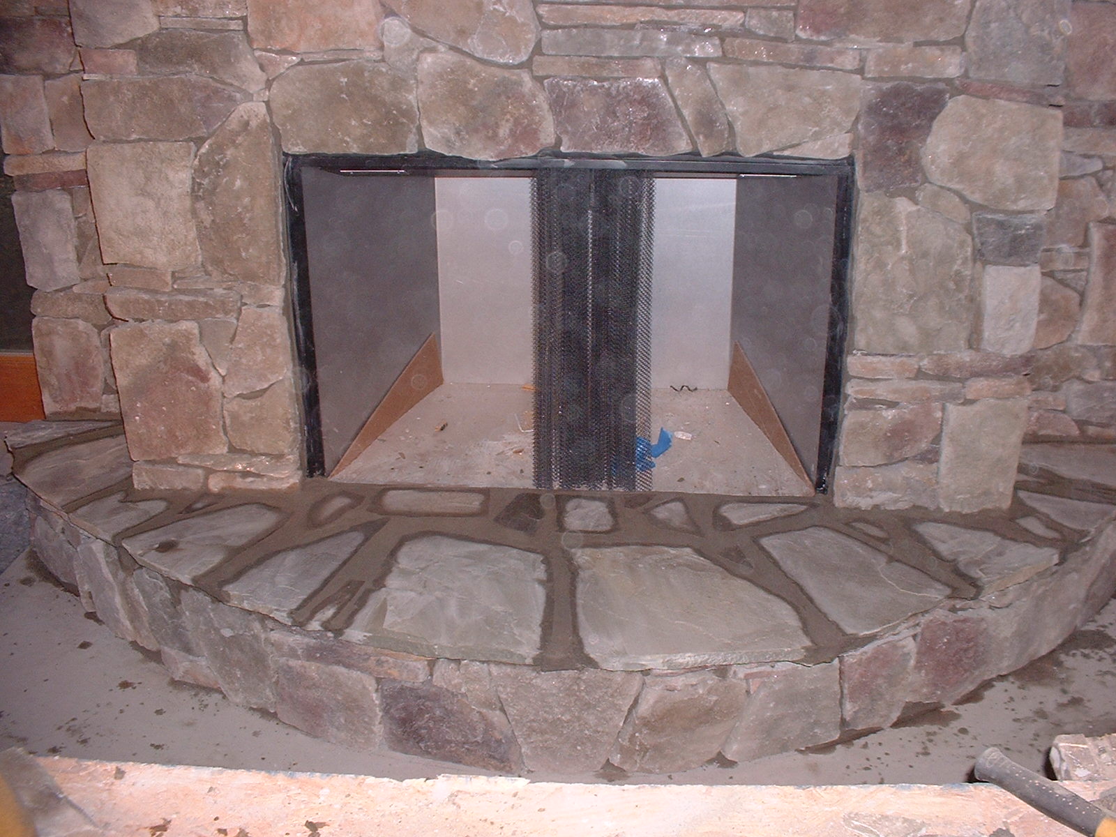 The top of the hearth is done with a natural stone.