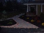  beautiful picture of the paver walkway with the lights on.